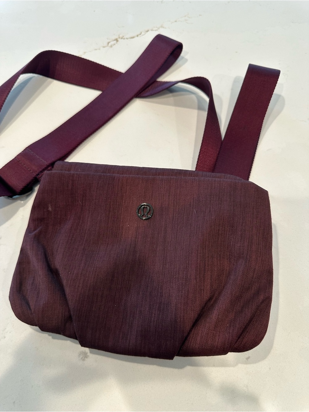 lululemon athletica Plum/ burgandy Crossbody Bag holds yoga mat.
Adjustable